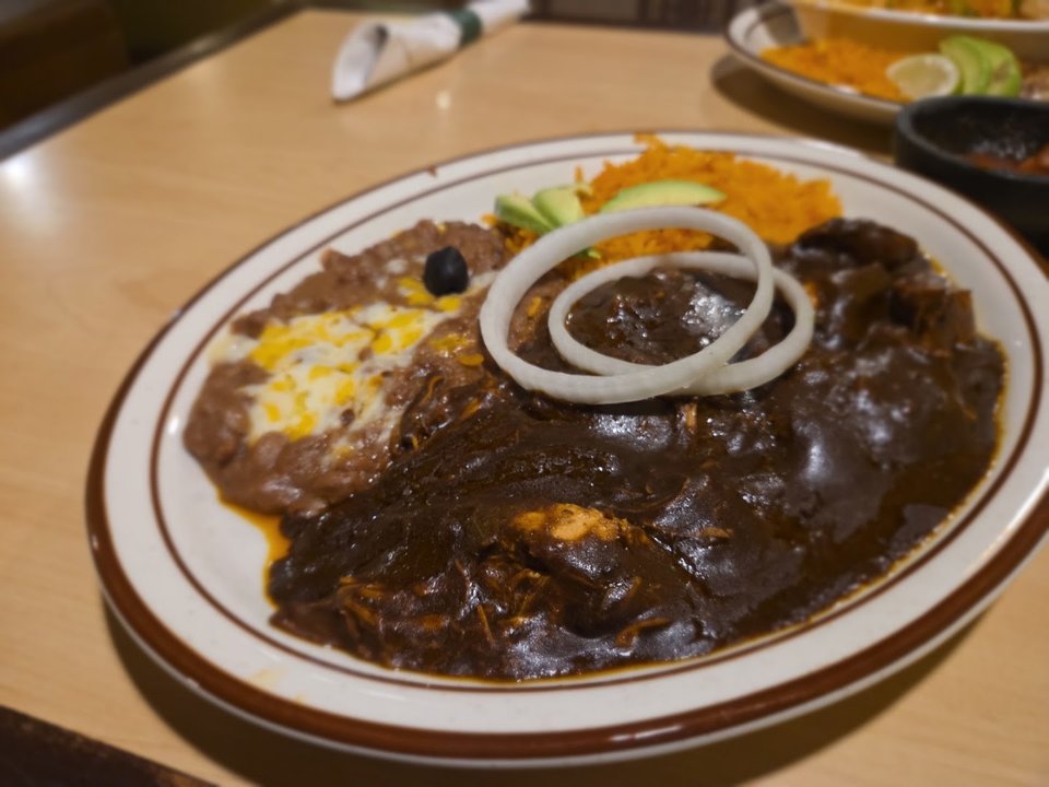 Plates of Mexican food on a restaurant table