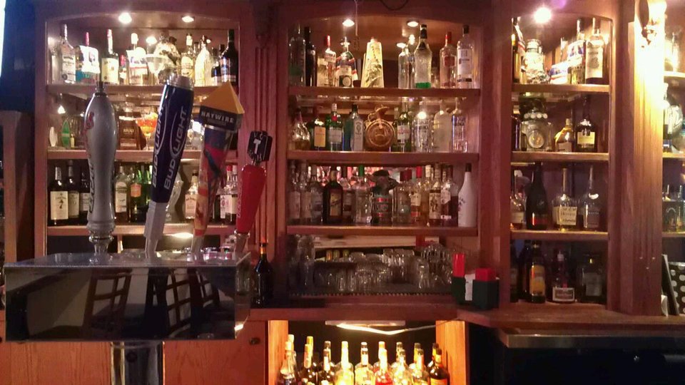 Bar seating with cocktails and beer glasses
